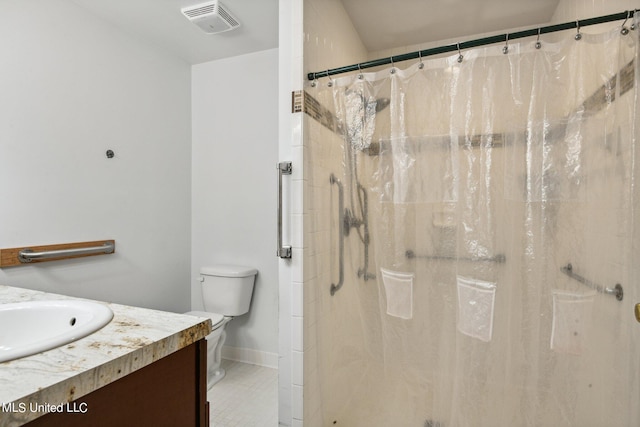 bathroom with vanity, toilet, curtained shower, and tile patterned flooring