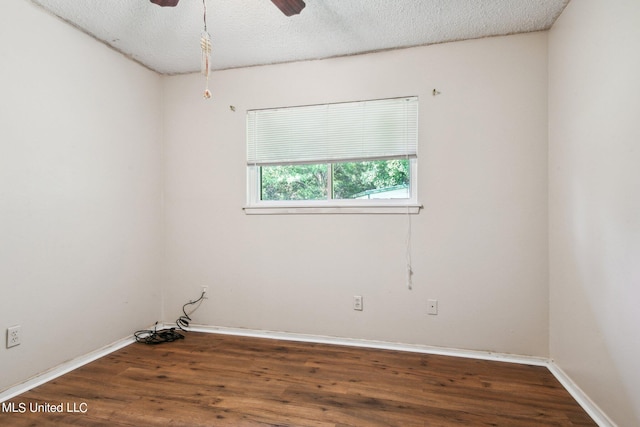 unfurnished room featuring a textured ceiling, dark wood-type flooring, and ceiling fan