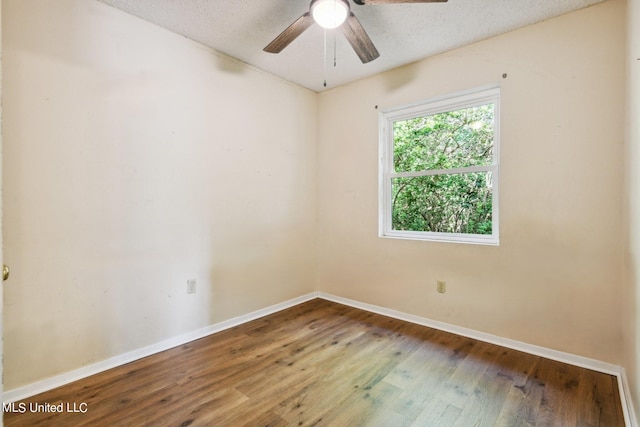 unfurnished room with ceiling fan, hardwood / wood-style flooring, and a textured ceiling