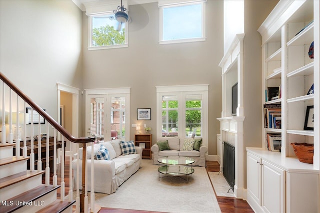 5264 Chappel Cv, Olive Branch, MS 38654 - living area with a fireplace with flush hearth, stairs, a high ceiling, and healthy amount of natural light