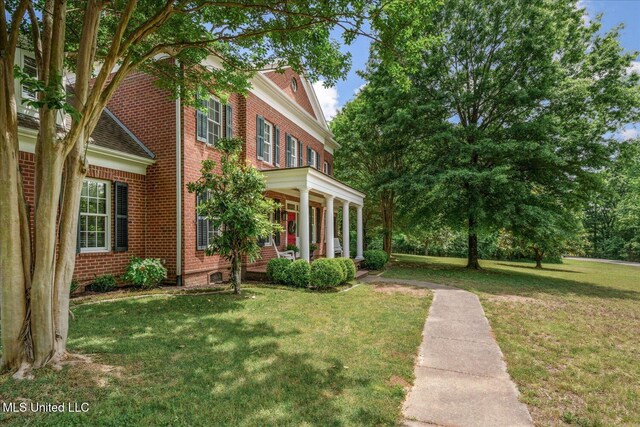 5264 Chappel Cv, Olive Branch, MS 38654 - view of side of property with brick siding, a yard, and a porch