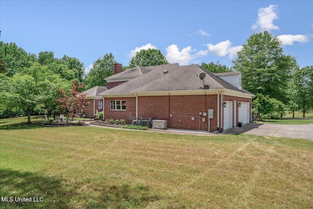 5264 Chappel Cv, Olive Branch, MS 38654 - back of house with a garage, a lawn, driveway, and a chimney