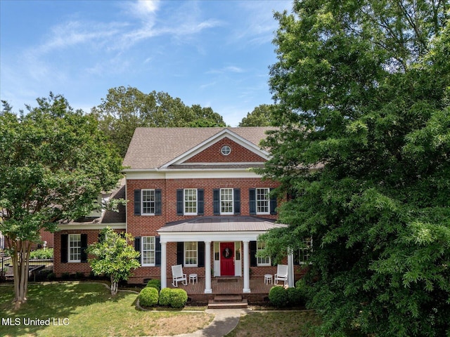 5264 Chappel Cv, Olive Branch, MS 38654 - colonial house featuring brick siding, covered porch, a front lawn, and a shingled roof
