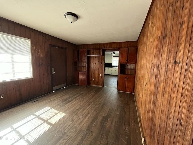 263 Shady Cir, Jackson, MS 39204 - unfurnished living room featuring dark wood-type flooring and wood walls