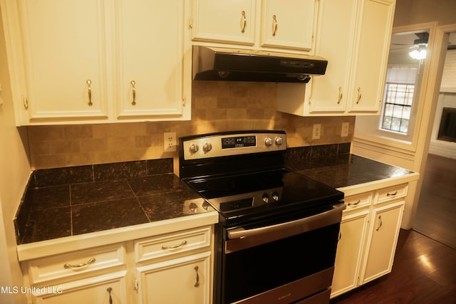 kitchen featuring dark hardwood / wood-style floors and stainless steel range with electric cooktop