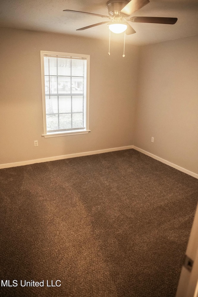 unfurnished room with ceiling fan and carpet