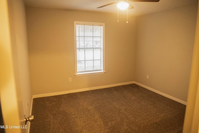 unfurnished room featuring ceiling fan and dark carpet