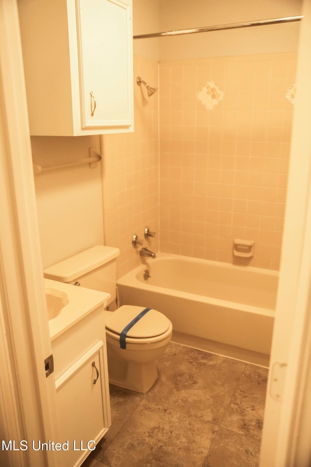 full bathroom with tiled shower / bath combo, vanity, and toilet