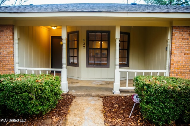 view of exterior entry with covered porch