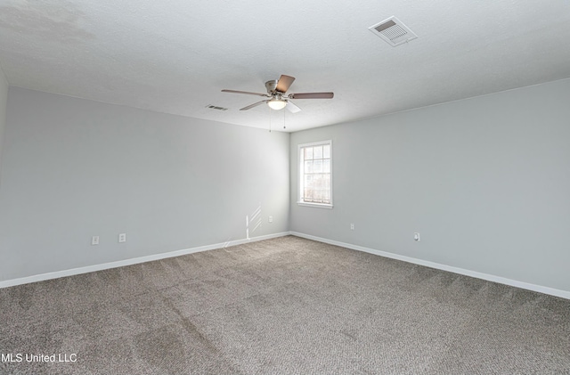 carpeted spare room with a textured ceiling and ceiling fan