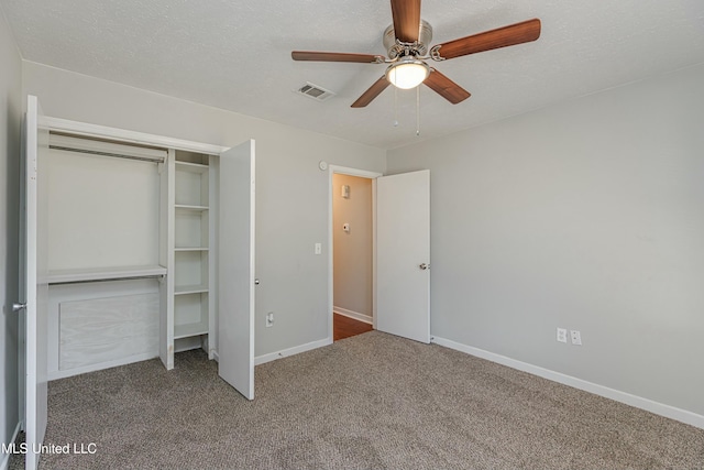 unfurnished bedroom with ceiling fan, a closet, carpet flooring, and a textured ceiling