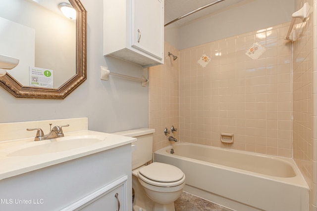 full bathroom with vanity, tiled shower / bath combo, and toilet