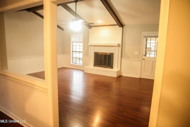 unfurnished living room featuring dark hardwood / wood-style flooring, a fireplace, and ceiling fan