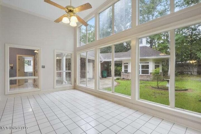 unfurnished sunroom with plenty of natural light and ceiling fan