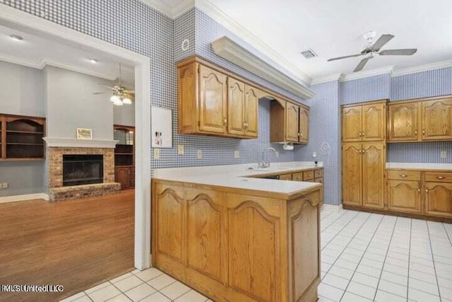 7828 Loa Pl, Diamondhead, MS 39525 - kitchen with ornamental molding, light countertops, a ceiling fan, and light tile patterned floors