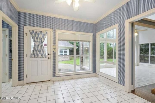 doorway to outside featuring crown molding, light wood-type flooring, and ceiling fan