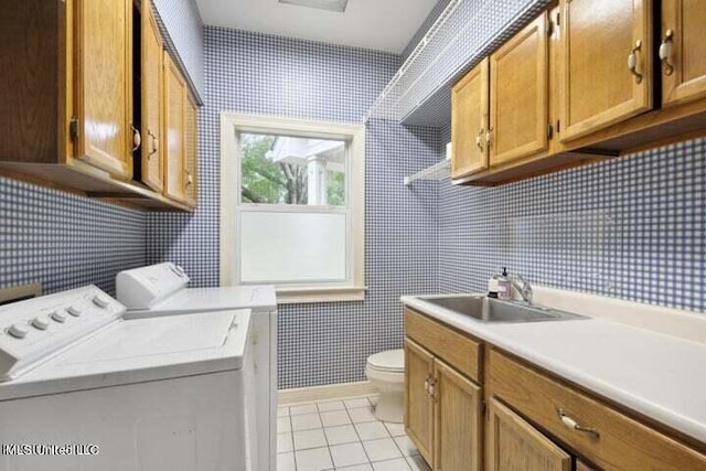 7828 Loa Pl, Diamondhead, MS 39525 - washroom featuring washing machine and dryer, a sink, wallpapered walls, laundry area, and light tile patterned flooring