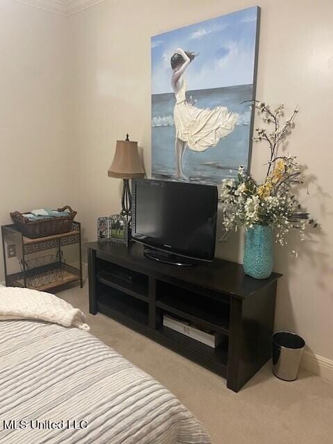 bedroom featuring crown molding and light colored carpet