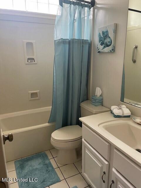 full bathroom with vanity, toilet, tile patterned flooring, and shower / tub combo with curtain