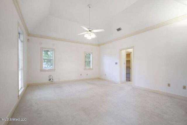 carpeted spare room featuring lofted ceiling, ornamental molding, and ceiling fan