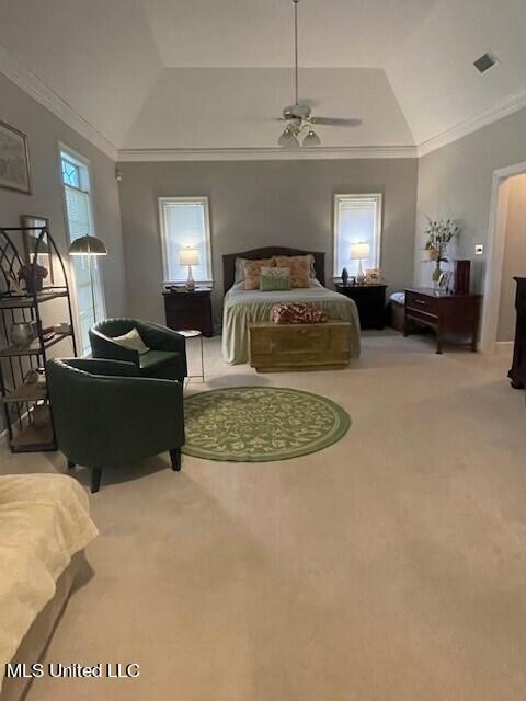 carpeted bedroom featuring crown molding, lofted ceiling, and ceiling fan