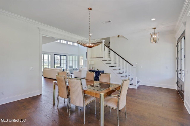 dining room with ornamental molding, french doors, dark hardwood / wood-style floors, and a notable chandelier