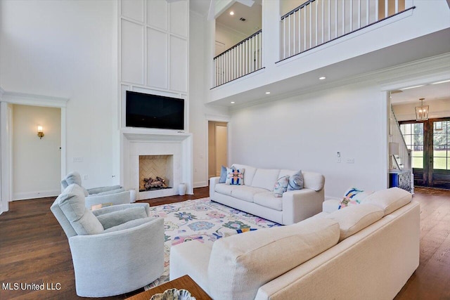 living room with dark wood-type flooring and a high ceiling