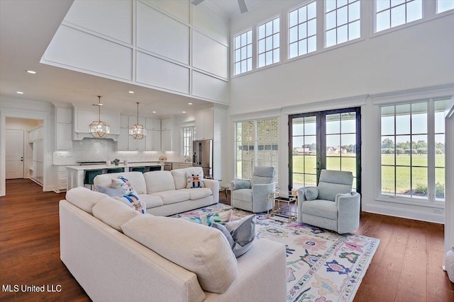 living room featuring french doors, dark wood-type flooring, and a high ceiling