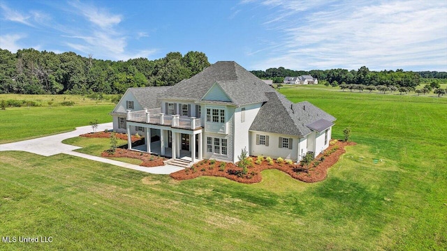 view of front facade featuring a balcony and a front lawn