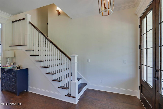 foyer featuring ornamental molding, french doors, dark hardwood / wood-style floors, and a wealth of natural light