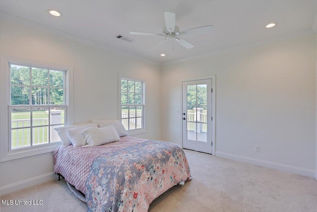 carpeted bedroom featuring access to outside, multiple windows, and ceiling fan