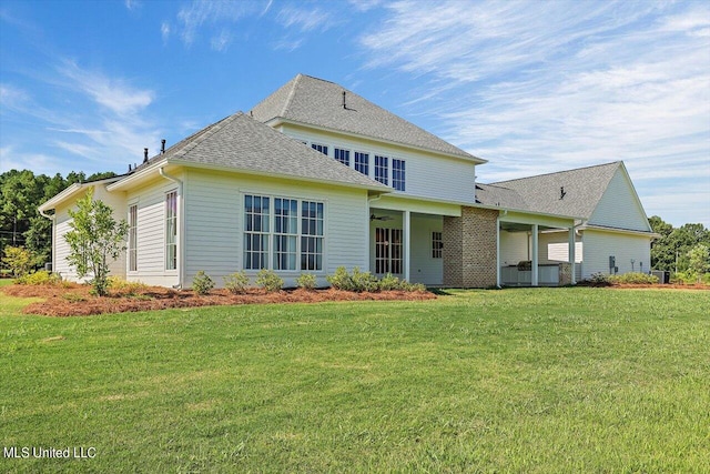 rear view of house with a lawn