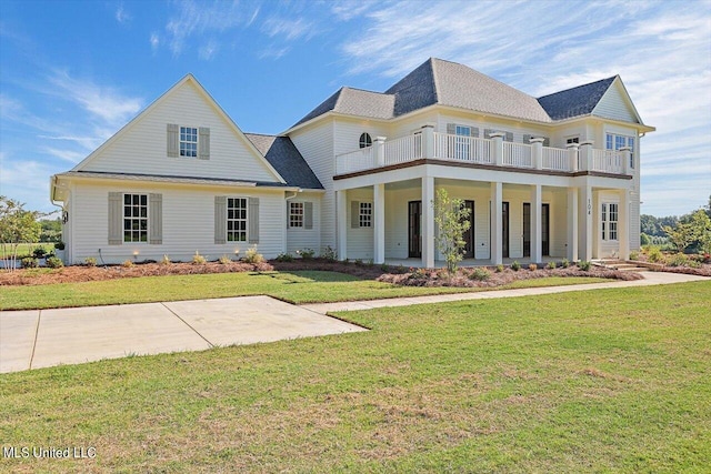 view of front of home featuring a front lawn and a balcony