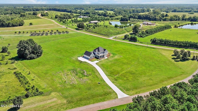 birds eye view of property featuring a water view and a rural view