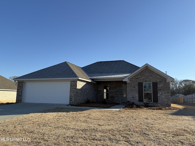 view of front facade with a garage and a front lawn