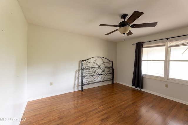 empty room featuring hardwood / wood-style flooring and ceiling fan