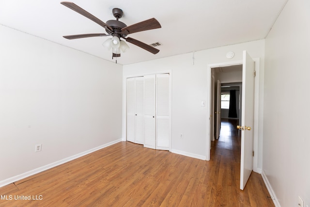 unfurnished bedroom with a closet, ceiling fan, and hardwood / wood-style floors