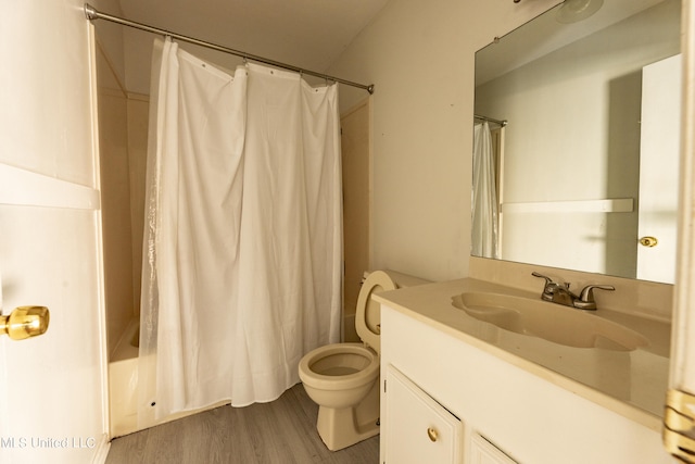 full bathroom with vanity, shower / bath combo with shower curtain, toilet, and hardwood / wood-style flooring