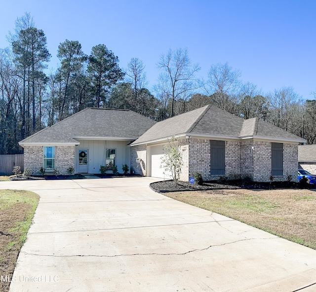 single story home with a garage, brick siding, driveway, and roof with shingles