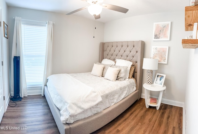 bedroom featuring a ceiling fan, baseboards, and wood finished floors