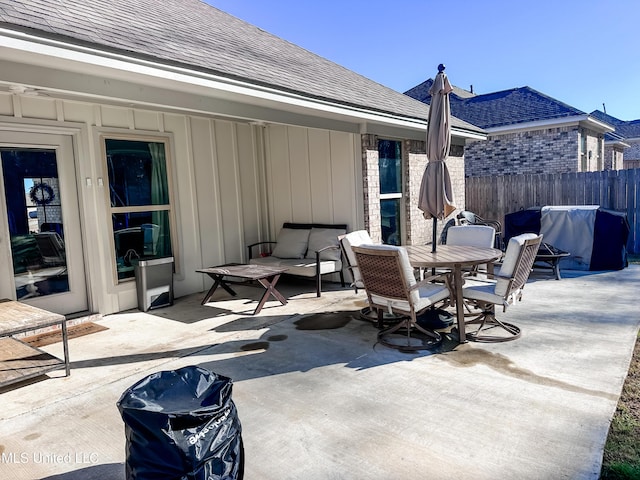 view of patio with an outdoor hangout area and fence