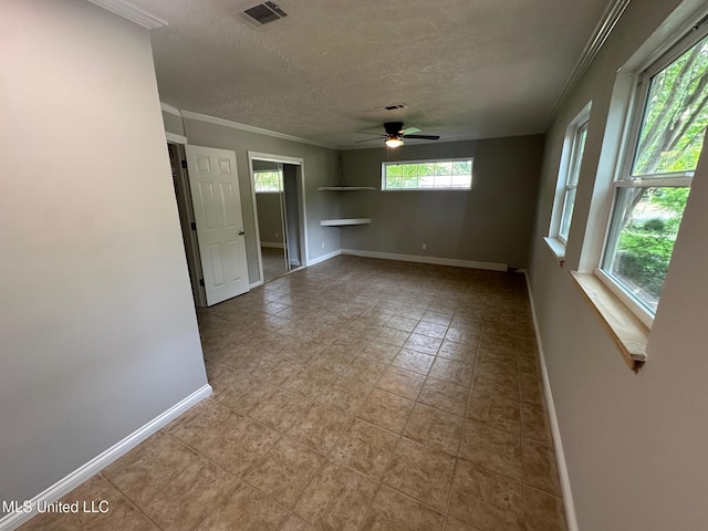 365 Gatewood Dr, Pearl, MS 39208 - tiled empty room featuring a ceiling fan, crown molding, baseboards, and a textured ceiling