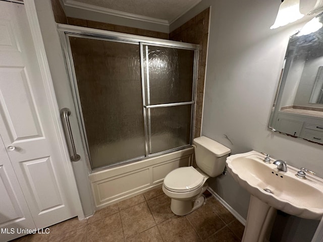 365 Gatewood Dr, Pearl, MS 39208 - bathroom featuring toilet, combined bath / shower with glass door, tile patterned floors, crown molding, and baseboards