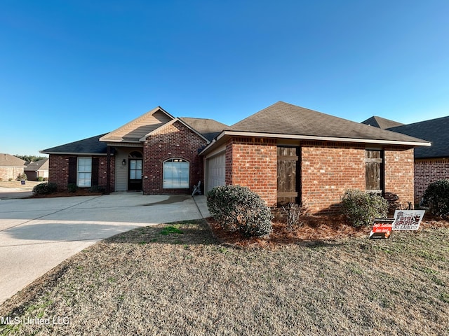 single story home with brick siding, a garage, driveway, and roof with shingles