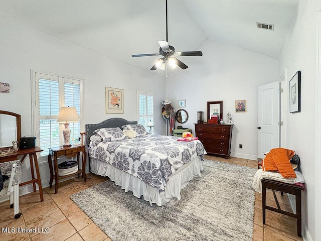 bedroom featuring high vaulted ceiling, light tile patterned flooring, visible vents, and multiple windows