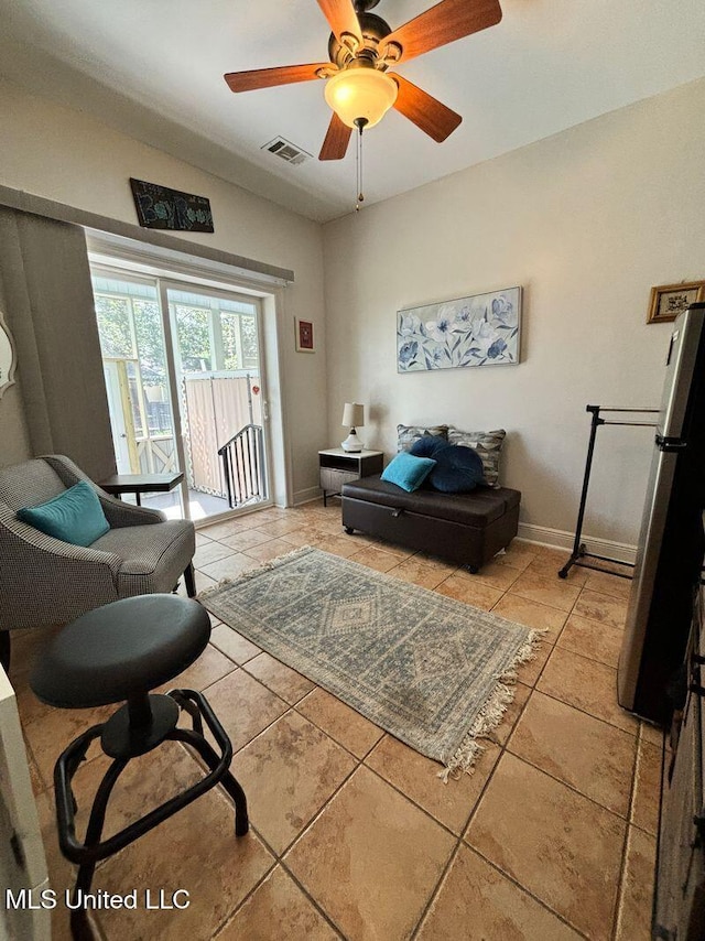 sitting room with visible vents, ceiling fan, baseboards, and light tile patterned flooring