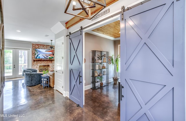 150 Pine Ridge Cir, Brandon, MS 39047 - interior space featuring a barn door, crown molding, baseboards, and finished concrete floors