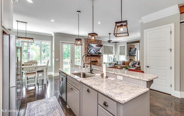 150 Pine Ridge Cir, Brandon, MS 39047 - kitchen featuring an island with sink, baseboards, appliances with stainless steel finishes, and a sink