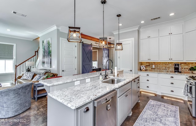 150 Pine Ridge Cir, Brandon, MS 39047 - kitchen with a barn door, a sink, stainless steel appliances, and visible vents