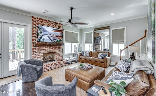 150 Pine Ridge Cir, Brandon, MS 39047 - living area with visible vents, stairway, ceiling fan, a fireplace, and ornamental molding